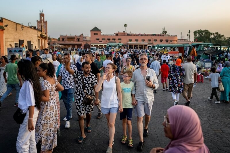tourists roaming around in morocco local market 