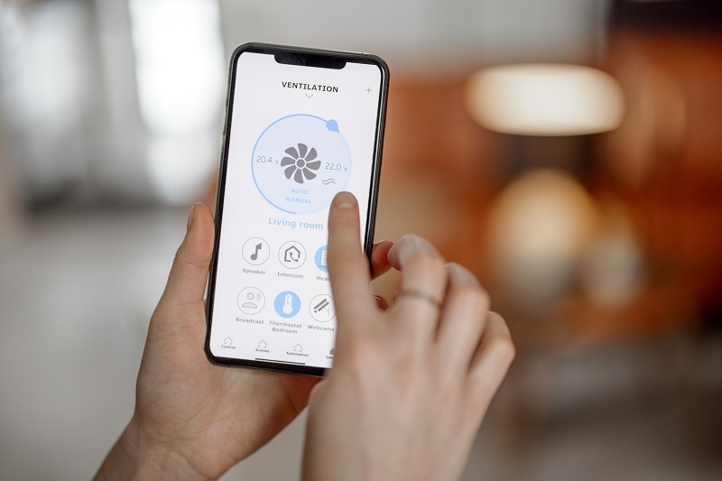 Smartphone with launched application for ventilation adjustment, air quality monitoring. Health microclimate at home concept. 