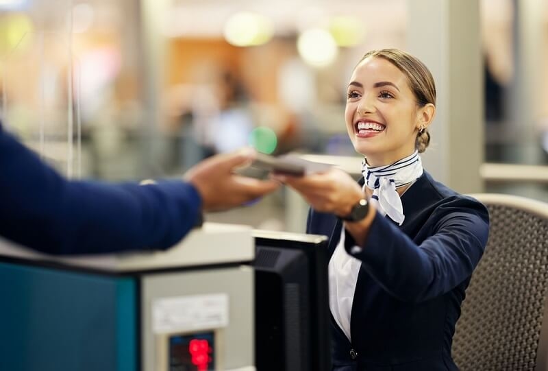 airport woman handling customer with a smile
