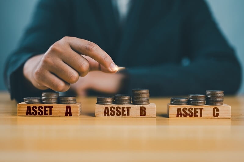 business man practicing asset allocation strategy with three asset blocks