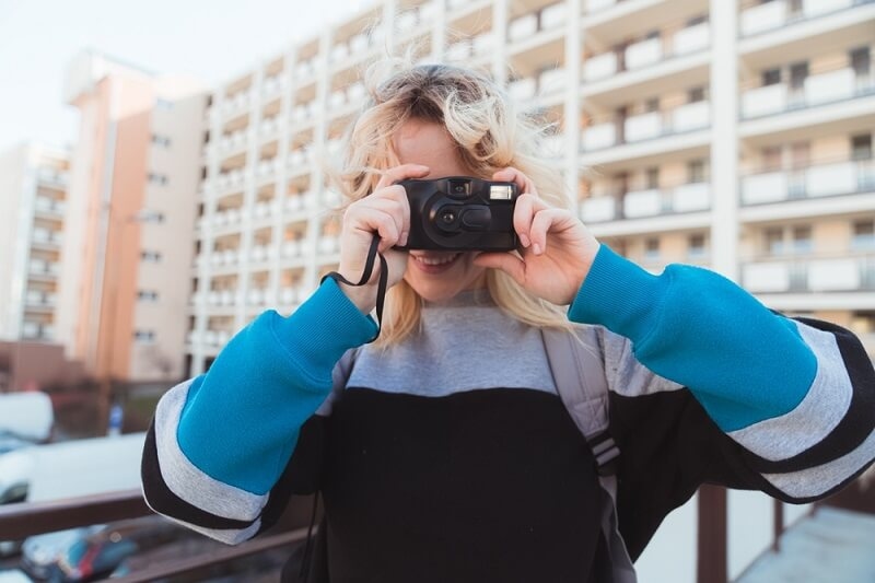 Young woman clicking pictures with camera