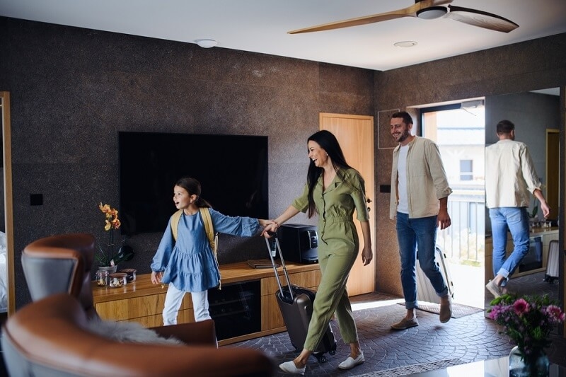family with kids check in to resort 