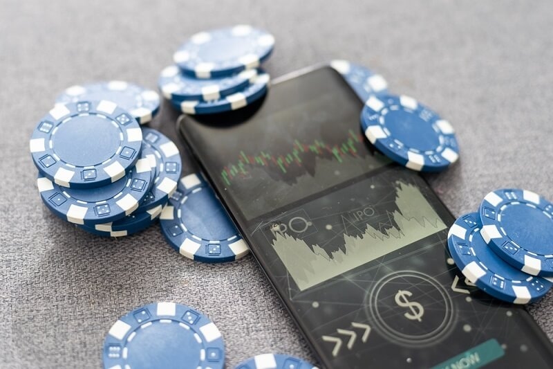 blue chip tokens with stock market graph and trends in smartphone