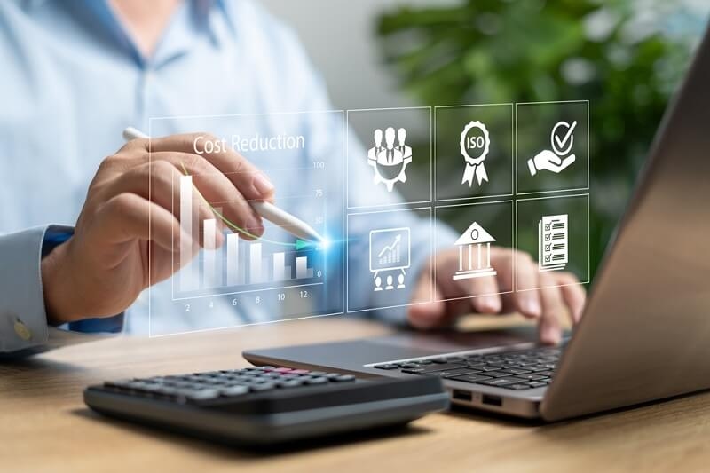 businessman calculating cost reduction through data and calculator