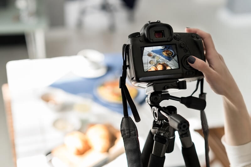 beginner camera woman taking pictures of food