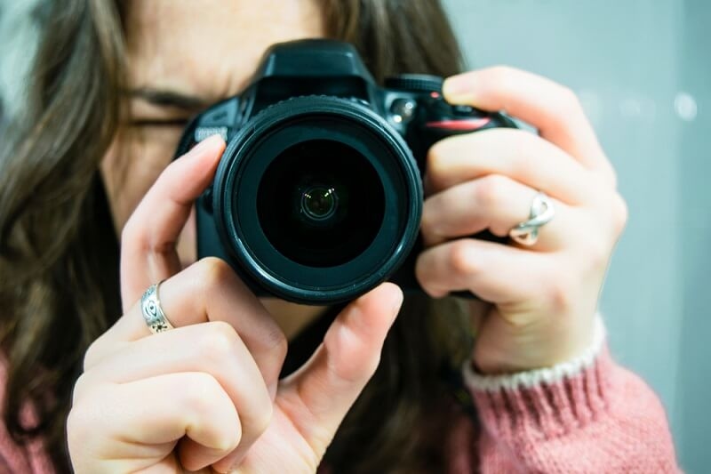 girl holding entry level camera 