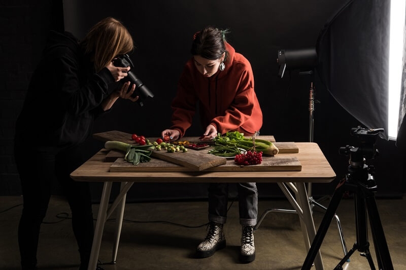 woman photographer clicking pictures of food