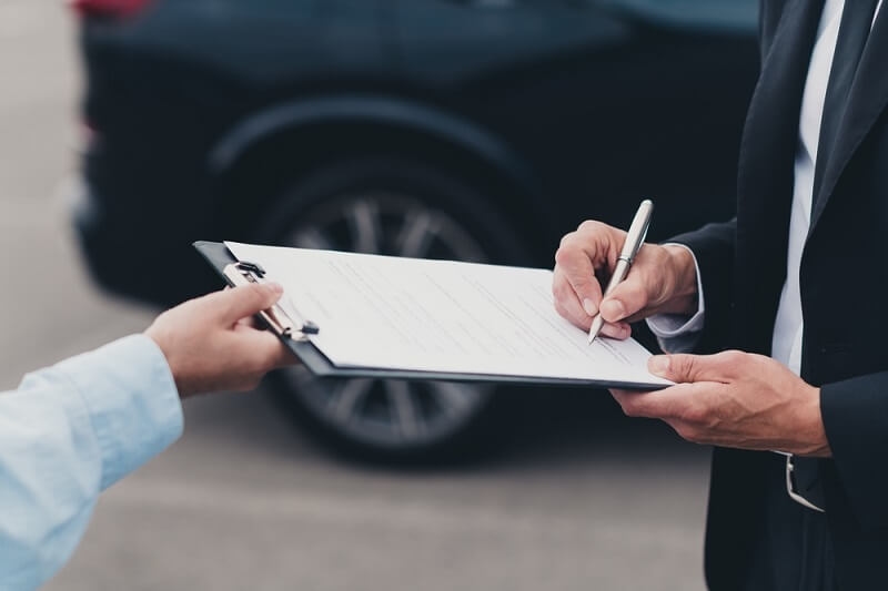 insurance agent signing on documents