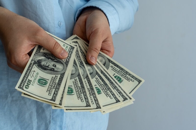 man counting dollar notes