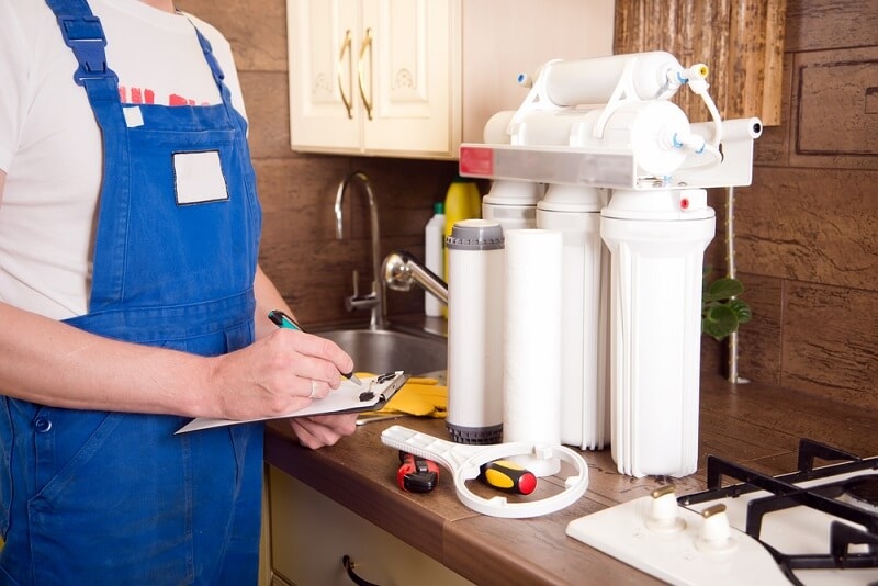 technician checking filters of purifier