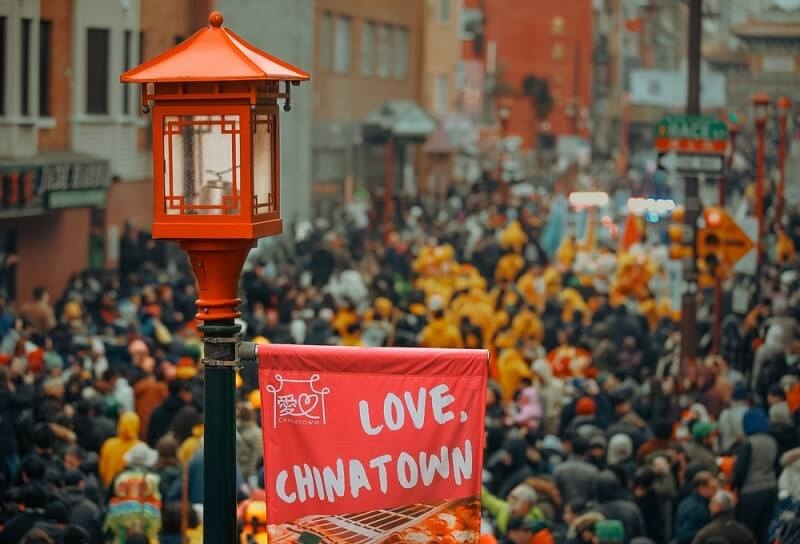 view of people in chinatown with love chinatown board