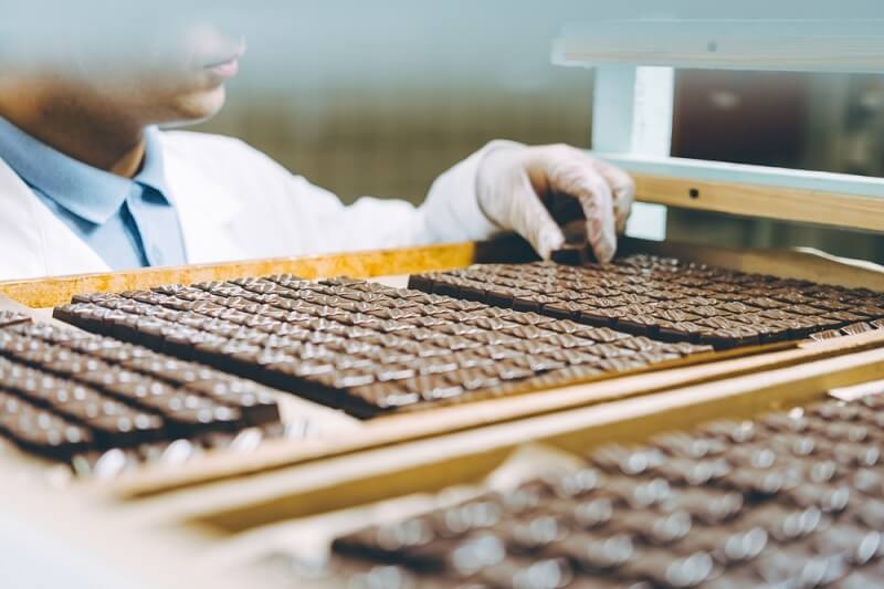 worker arranging chocolates 