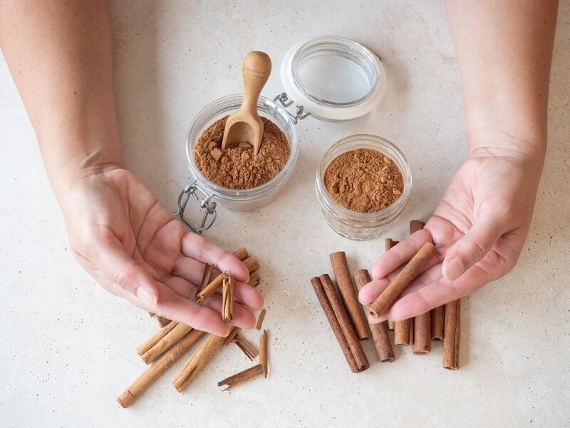 woman showing different types of cinnamon 