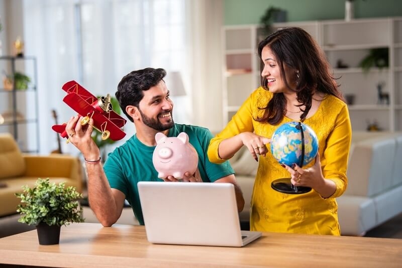 couple making travel discounts plan while getting deals on laptop