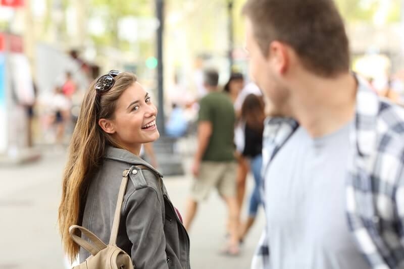 couple staring at each other in public and smiling