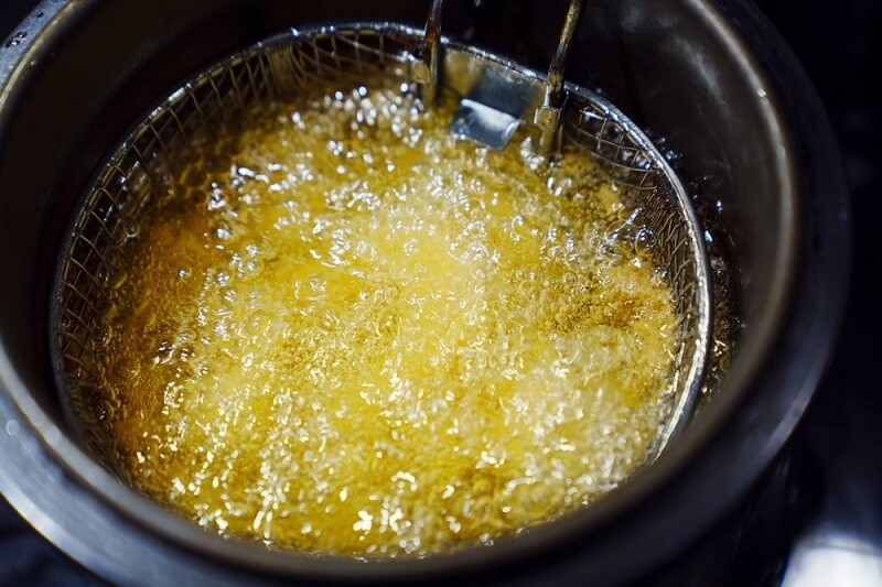 potatos in kitchen in deep fryer