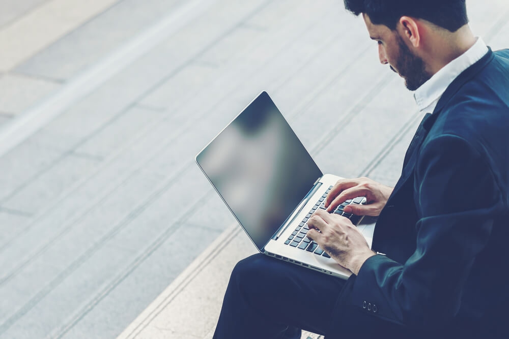 man working remotely while wearing suits