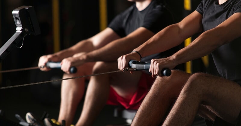 two men doing anaerobic exercise in gym