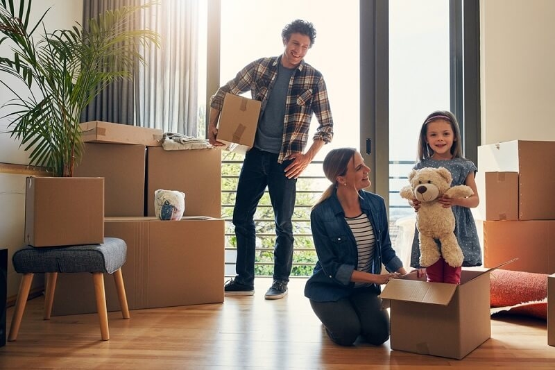couple shifting stuff in new home with thier daughter