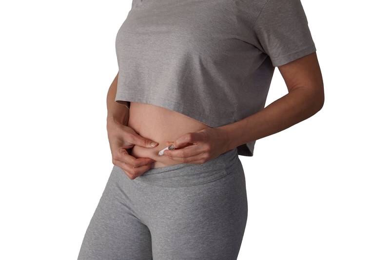 woman giving herself injection of GLP-1 