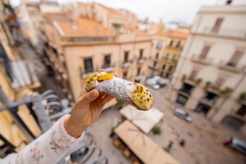 hand-holds-traditional-sicilian-cannolo