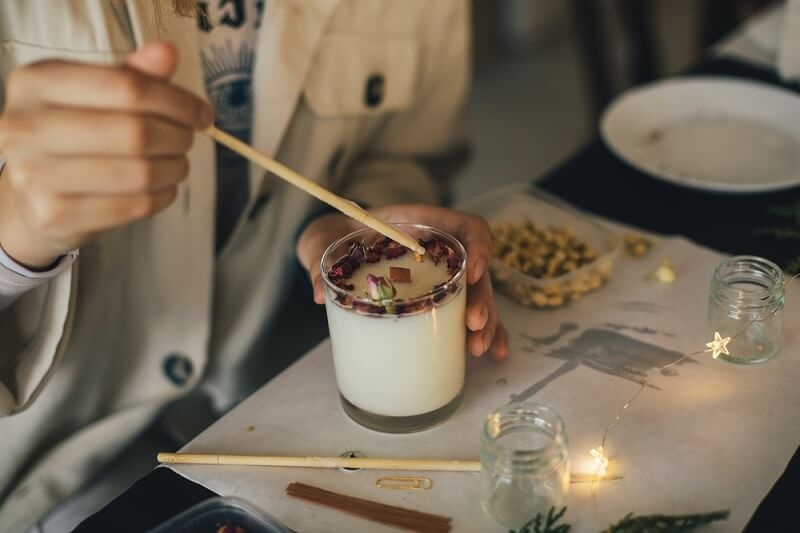 woman making soy candle for gifting