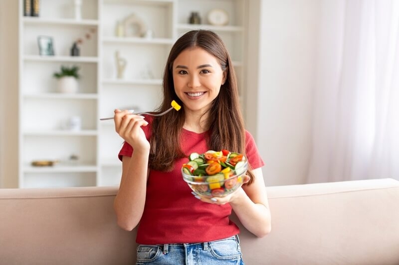 woman eating healthy food for glowing skin