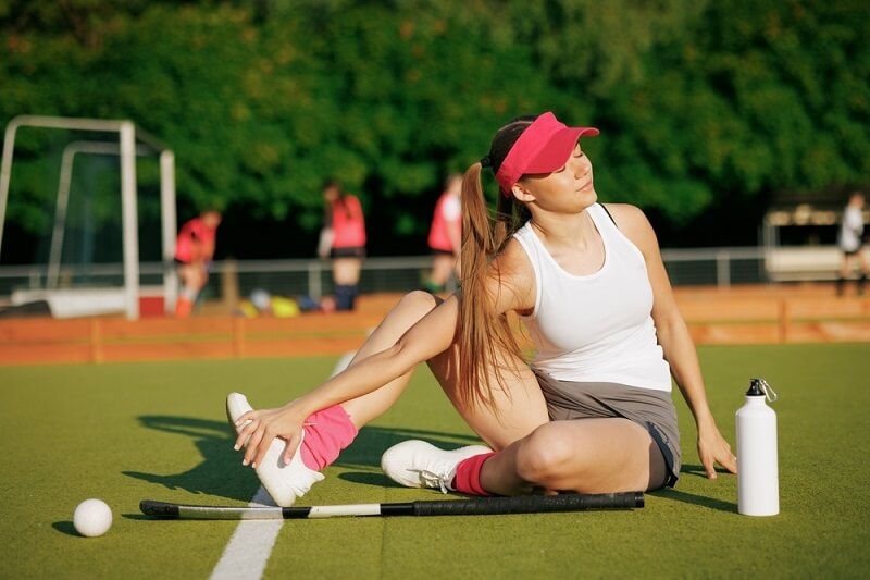 beautiful woman doing stretching exercise in field