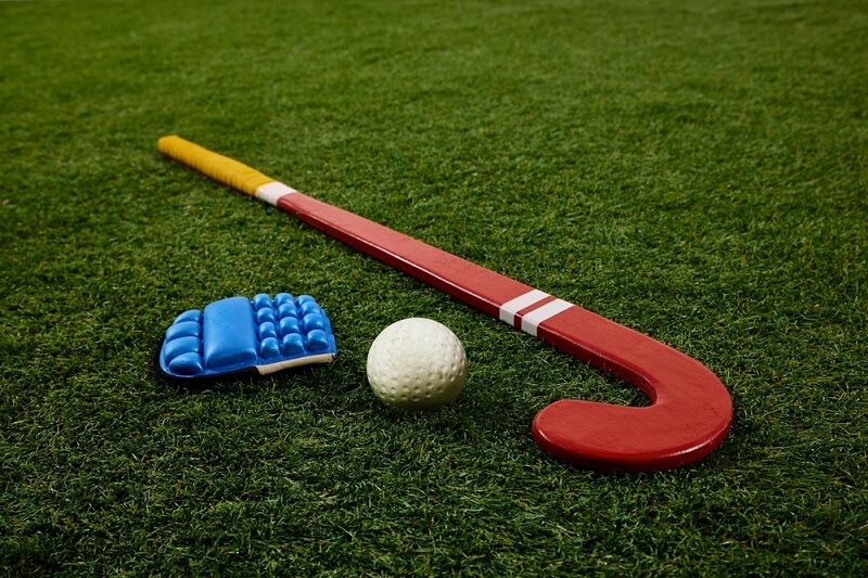 Hockey stick with ball and gloves