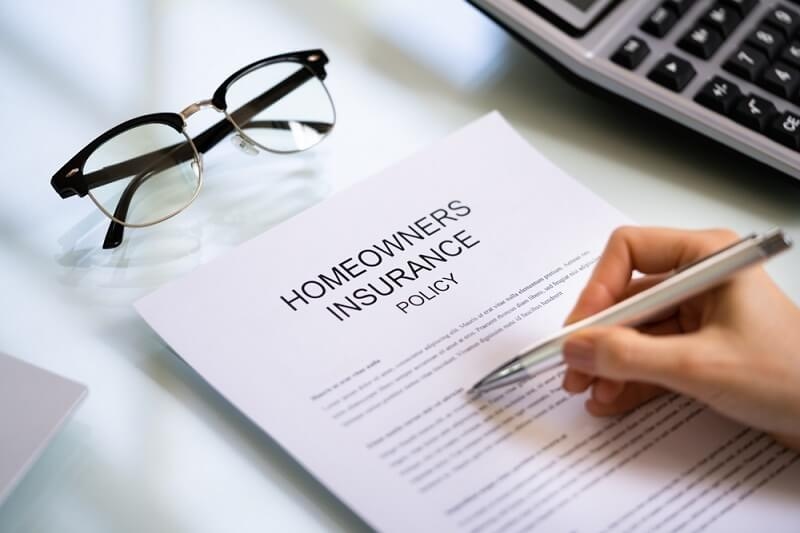 woman checking homeowners insurance policy documents