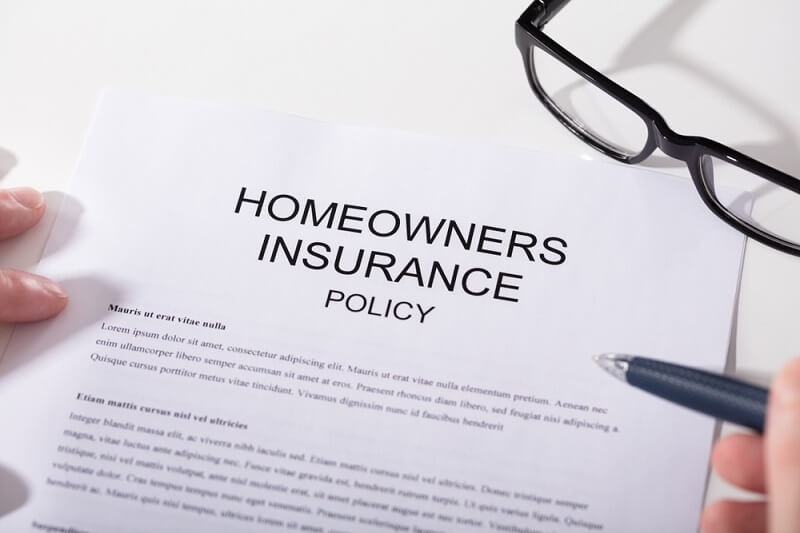 homeowner insurance policy with eye glasses and pen