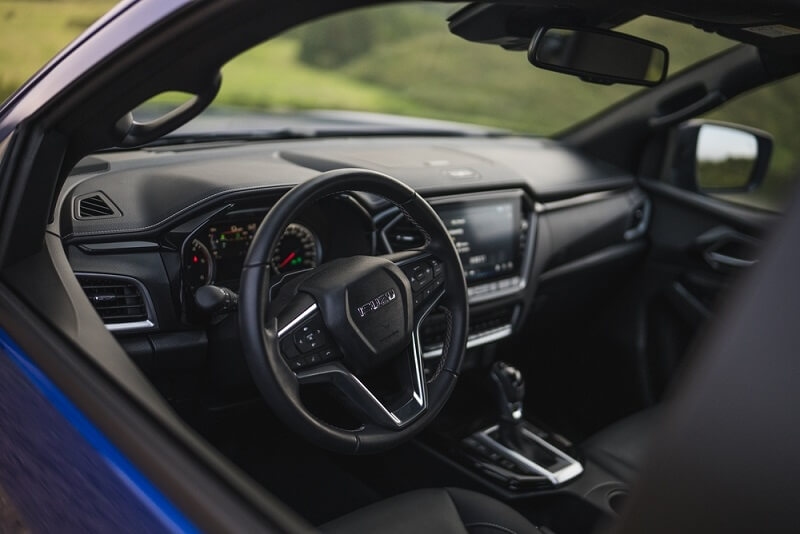 side view from window of interior of isuzu car
