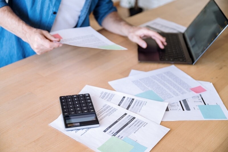 man tracking records and expenses of insurance 