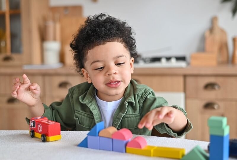 american kid with learning toys
