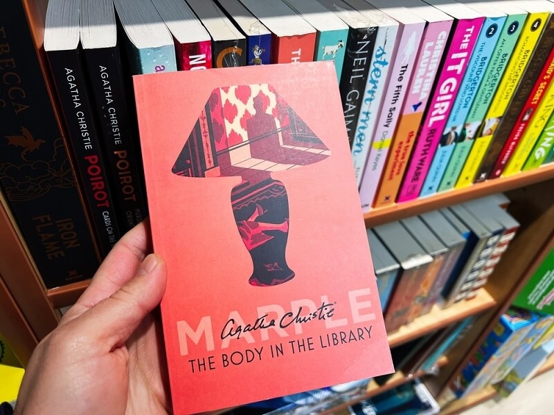 man holding the body in the library book