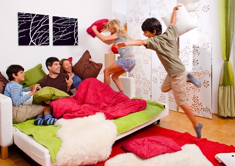 family enjoying and playing on family living room