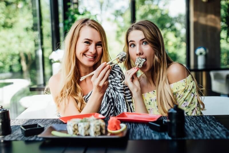 two girls enjoying food and flavors