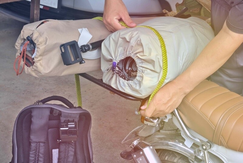 man binding his stuff with rope 