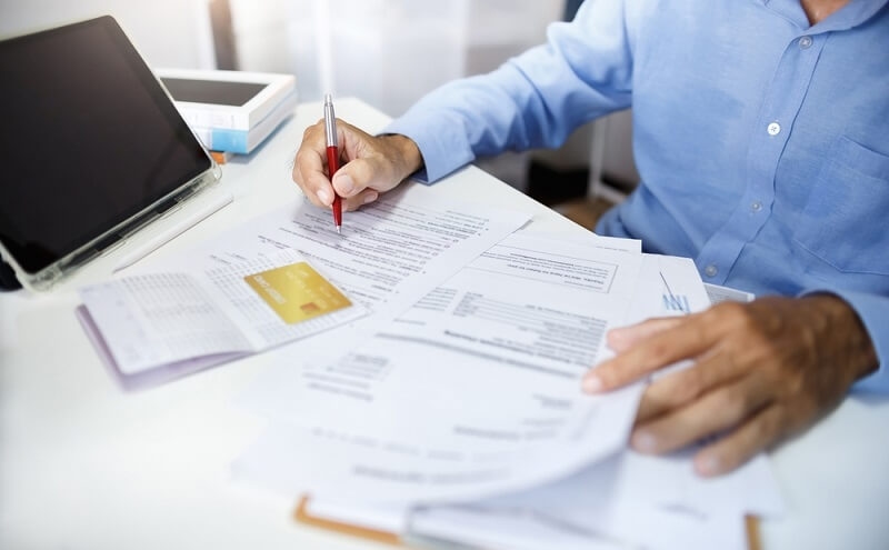 man checking his account details before credit report