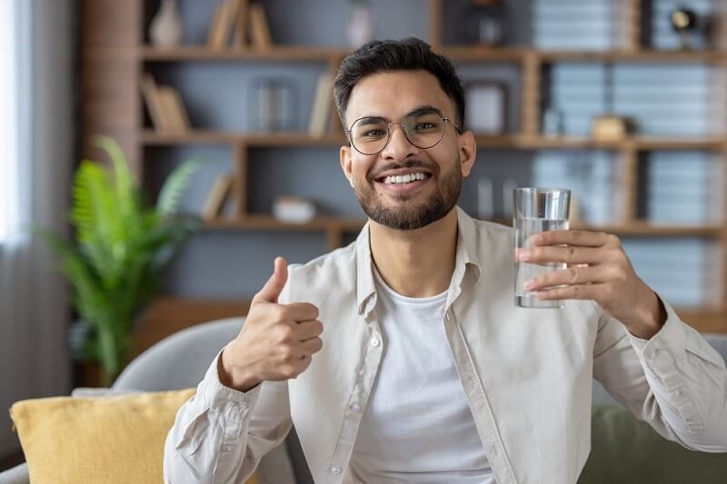 man holding a glass of water