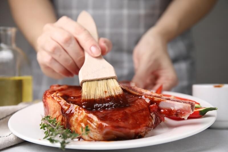 woman marinating meat
