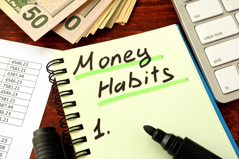 Notepad with word Money Habits. Saving and planning concept.
