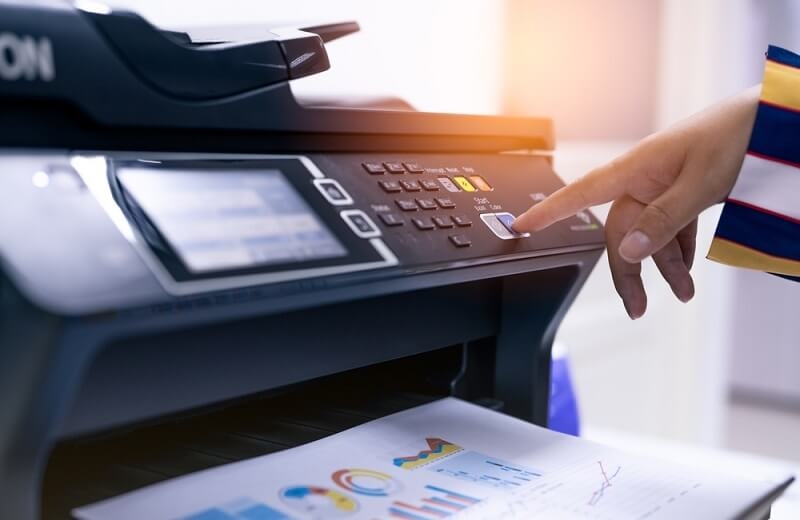 man working on an multifunctional printer