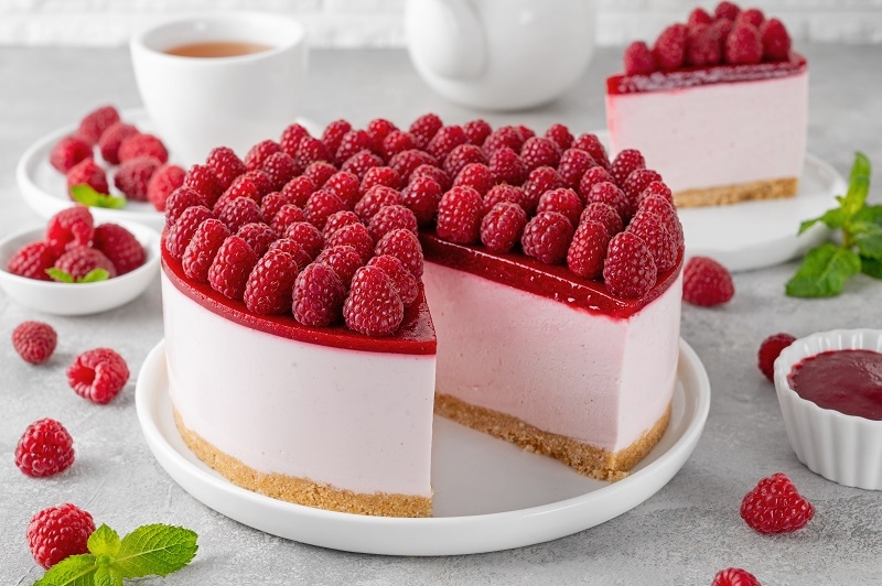 No baked raspberry cheesecake or raspberry cream mousse cake with jelly and fresh berries on top