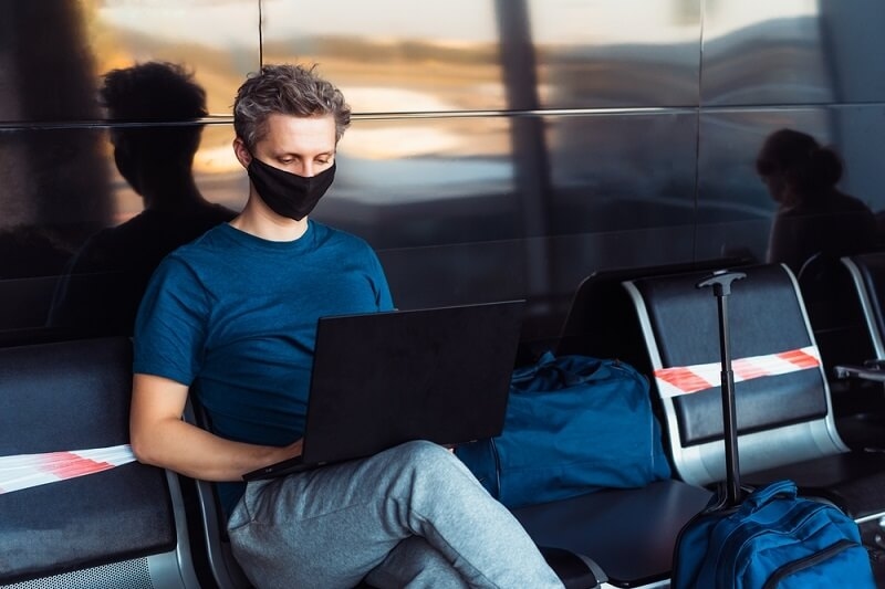 Digital nomad insurance coverage man at airport