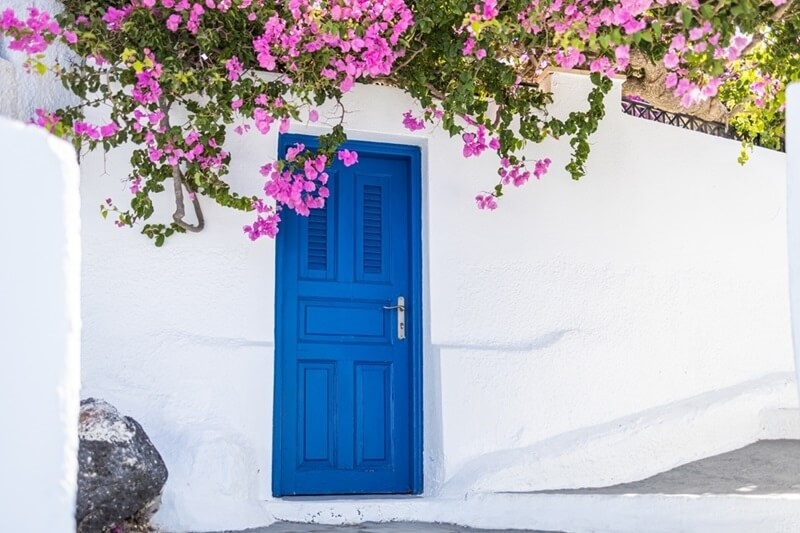 old-blue-door-pink-flowers-santorini