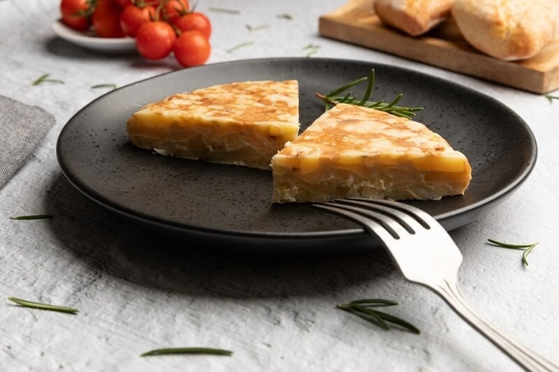 potato and egg omelet eaten with knife