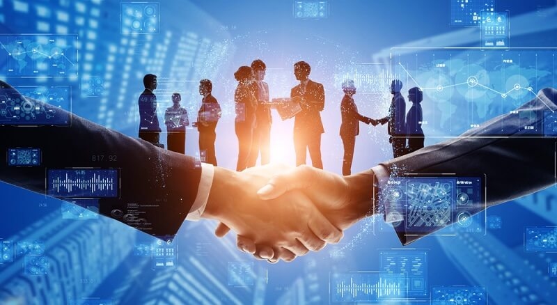two businessman handshaking as online business buyer and seller and other people were also talking in backgrounf