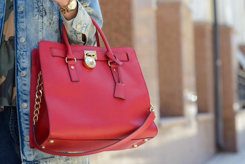 Stylish glamorous female leather bag on the street outdoor background