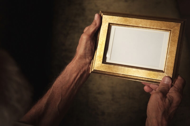 old man holding hand made customized frame